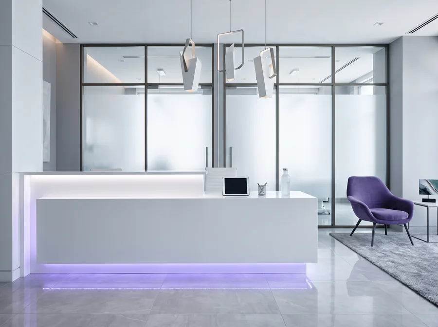 Modern med spa reception with illuminated violet counter